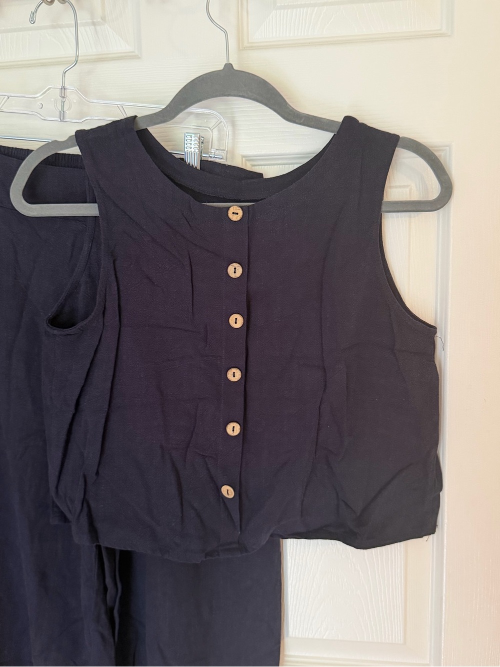 Black Button-Front Sleeveless button top with matching wide leg pant.
